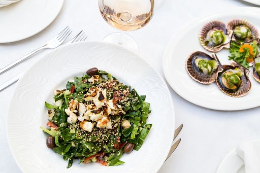 A top viewof healthy salad with spinach, sesame seeds, and olives