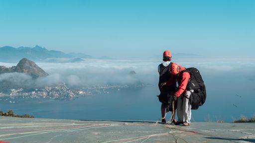 A couple of paragliders preparing for a jump off a cliff in Brazi
