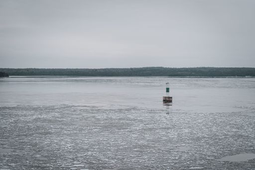 A small industrial construction in the sea reflected in the water