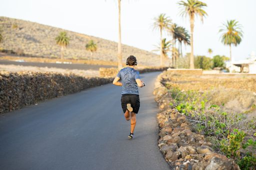 An athletic man running during the outdoors morning workout