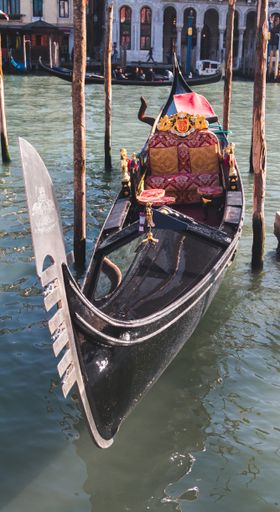 A vertical shot of a boat near the dock on the water in Italy