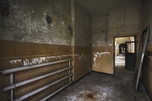 The inside of an old abandoned building with rusty walls