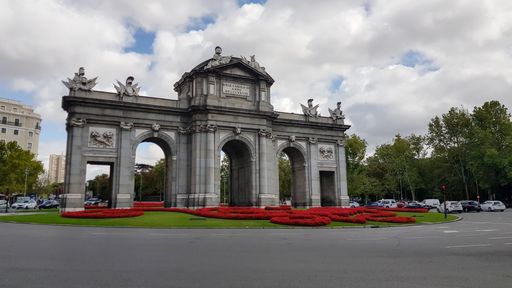 The Puerta de Alcala Neo-classical gate in Madrid during day with traffic
