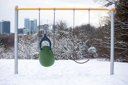 A view of a swing in the snowy East don park in Toronto, Canada