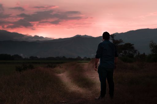 A man enjoying the view of a beautiful mountainous landscape during sunset