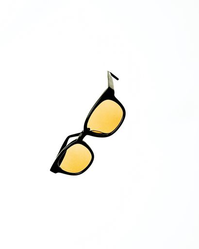 A closeup vertical shot of stylish sunglasses isolated on a white background