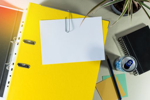 A top view of office folder with copy space and other office supplies on desk - education concept