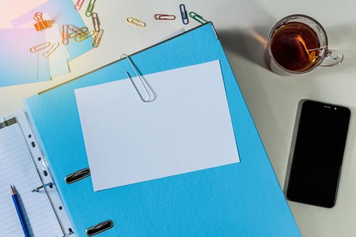 A top view of office folder with copy space and other office supplies on desk - education concept