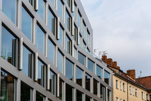 A facade of a business center building with large windows, modern architecture of Berlin