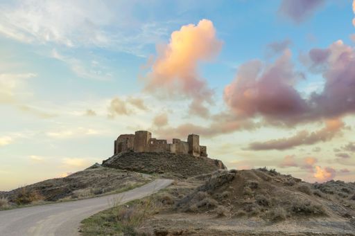 View of the ruins of the abandoned medieval castle of Montearagon at sunset, located on top of a mountain near Huesca, Aragon province, Spain.