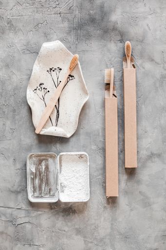 A vertical top view of eco-friendly zero waste toothbrushes with baking soda for personal hygiene