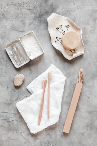 A vertical top view of eco-friendly zero waste bathroom supplies for personal hygiene