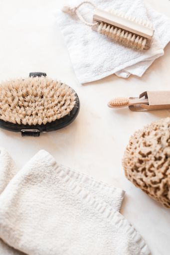 A vertical top view of natural plastic-free zero waste bathroom supplies for personal hygiene