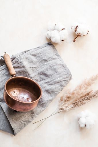 A vertical high angle shot of natural eco-friendly natural body care ingredients and fluffy cotton flowers