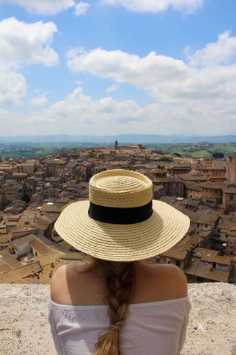 A vertical shot of a female wearing a straw hat