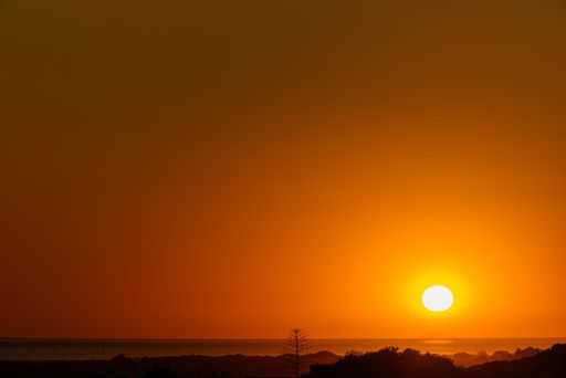 A beautiful shot of a bright sunset sky over the beach of Canos de Meca, Barbate, Cadiz