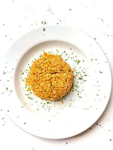 A traditional Nigerian dish of jelof rice served on a white plate