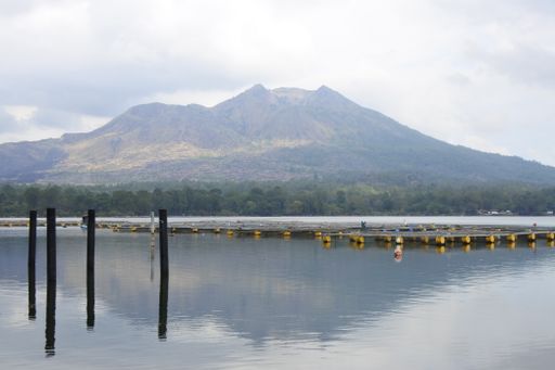 A fantastic shot of a calm lake on foggy mountain background