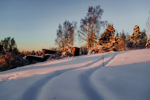 A trail on a sloping snowfield during winter