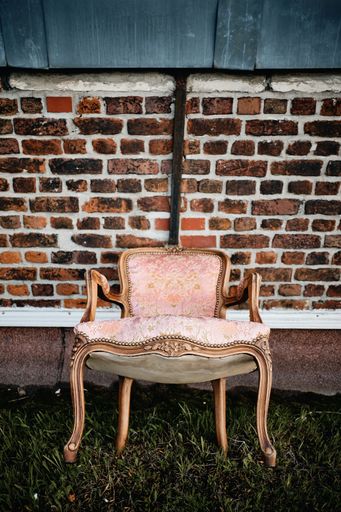 A nice chair in front of a brick wall on the grass in Roubaix, France