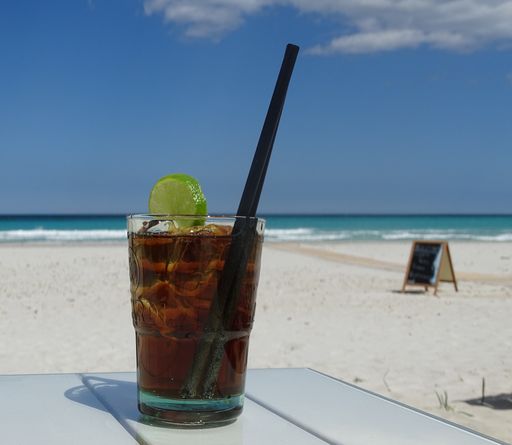 A closeup shot of a cocktail on beach background