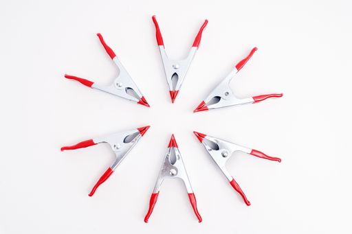 A top view of a circle of metal clamps isolated on a white background