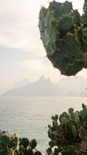A scenic view of the Dois Irmaos peak, seen from the Arpoador beach in Rio de Janeiro, Brazil