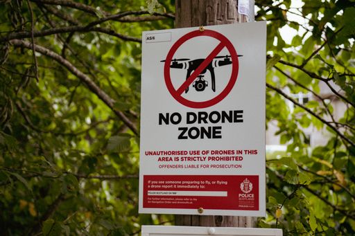 A sign board with No Drone Zone Sign