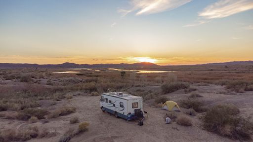 An aerial view of a campsite with an RV and a tent at Mittry Lake,  Arizona Desert