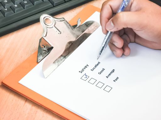 An image of a customer experience concept with a check box and a pen on an office table