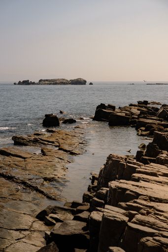 A vertical shot of rock formations near the shore in Punta del Timoncillo, Spain