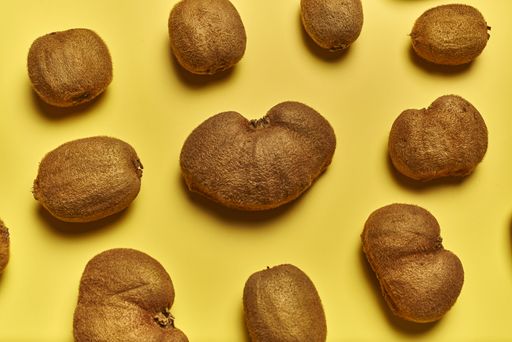 A top view of ripe kiwis isolated on a yellow background