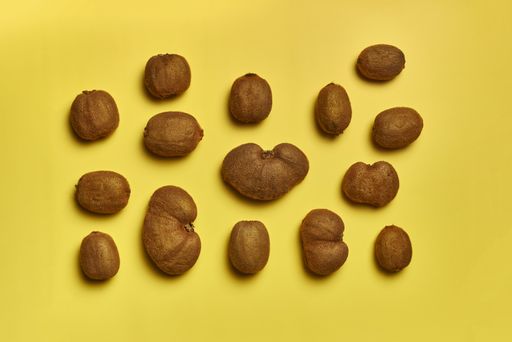 A top view of ripe kiwis isolated on a yellow background