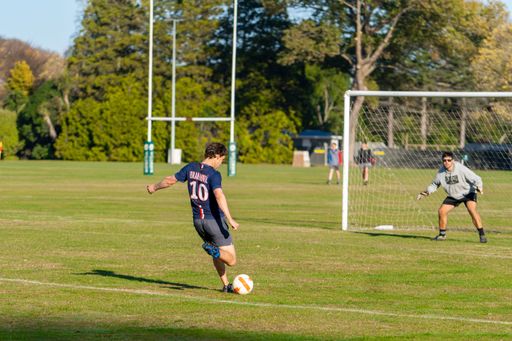 A team of Amateur Football in a field under the sunlight