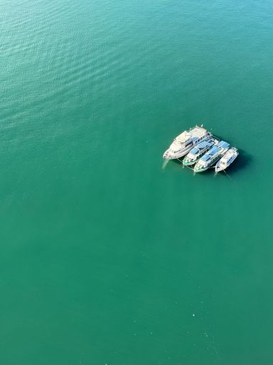 An aerial view of yacht in the middle of the blue ocean