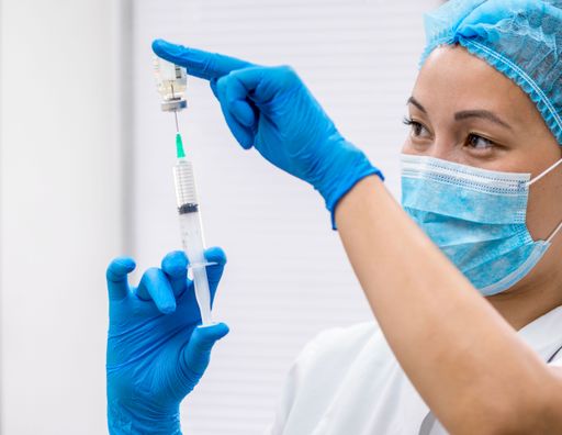 The doctor in the clinic room prepares a drip for patients