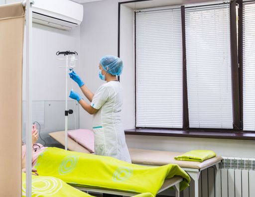 The doctor in the clinic room prepares a drip for patients