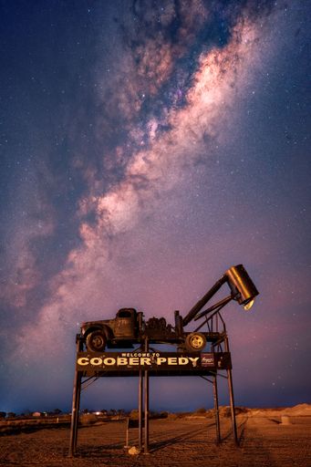 A coober pedy car under blissful Milky way in sky
