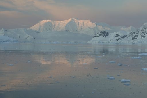 The Alpine glow on the beautiful mountains covered in snow in Antarctica