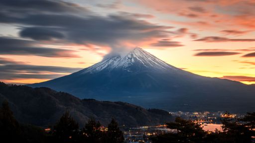 Dramatic view of Mount Fuji in Japan during a stunning sunset, with its snow-capped peak glowing in the warm evening light