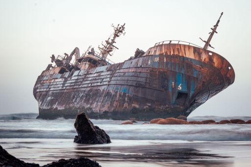 A beautiful shot of a historic dirty old ship after a shipwreck on a seashore