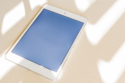 A tablet with blue screen on a desk - copy space, technology concept