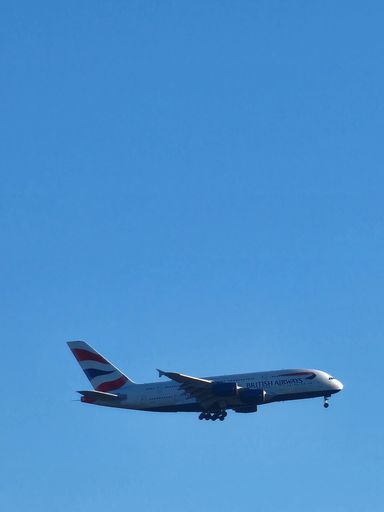 A vertical shot of a British Airways plane in a blue sky