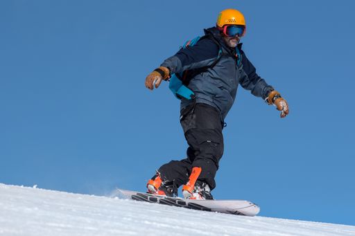 Grandvalira, Andorra: 2020 December 31: Man skating snowboard with Split board going down the mountains of the Pyrenees in Andorra on 2020.