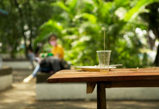 A selective focus shot of an empty cup in a park