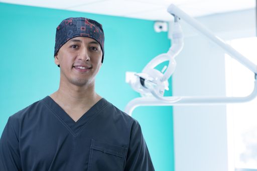 A portrait of a Hispanic dentist at his office