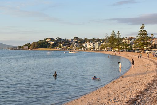 View of people swimming at Bucklands Beach on new 2021 year eve