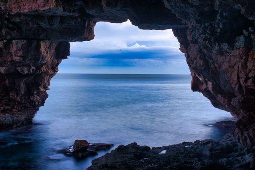 The cave of Cova dels Arcs at Moraig cove beach in Alicante, Spain