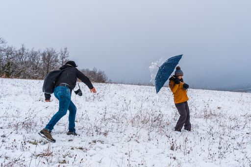 A couple playing with snowballs at a park during winter in the town of Opakua near Vitoria in Araba, Basque Country, Spain