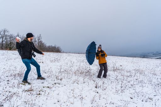 A couple playing with snowballs at a park during winter in the town of Opakua near Vitoria in Araba, Basque Country, Spain